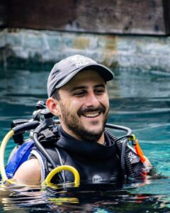 Anthony Cruz, PADI Course Director, smiling in the training pool at Bongo Bongo Divers